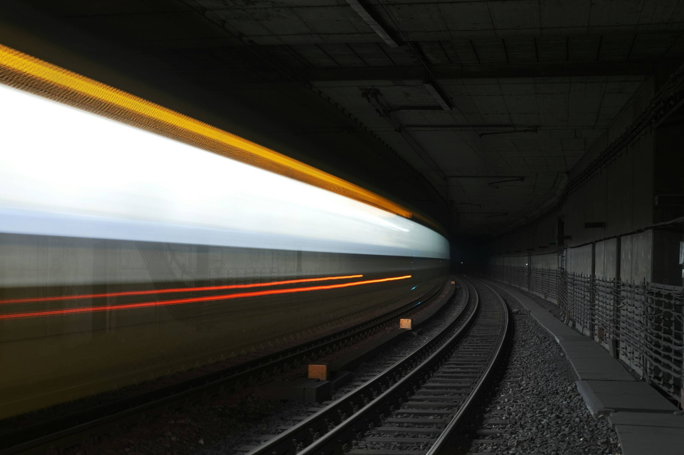 Light trails of a train racing through a tunnel